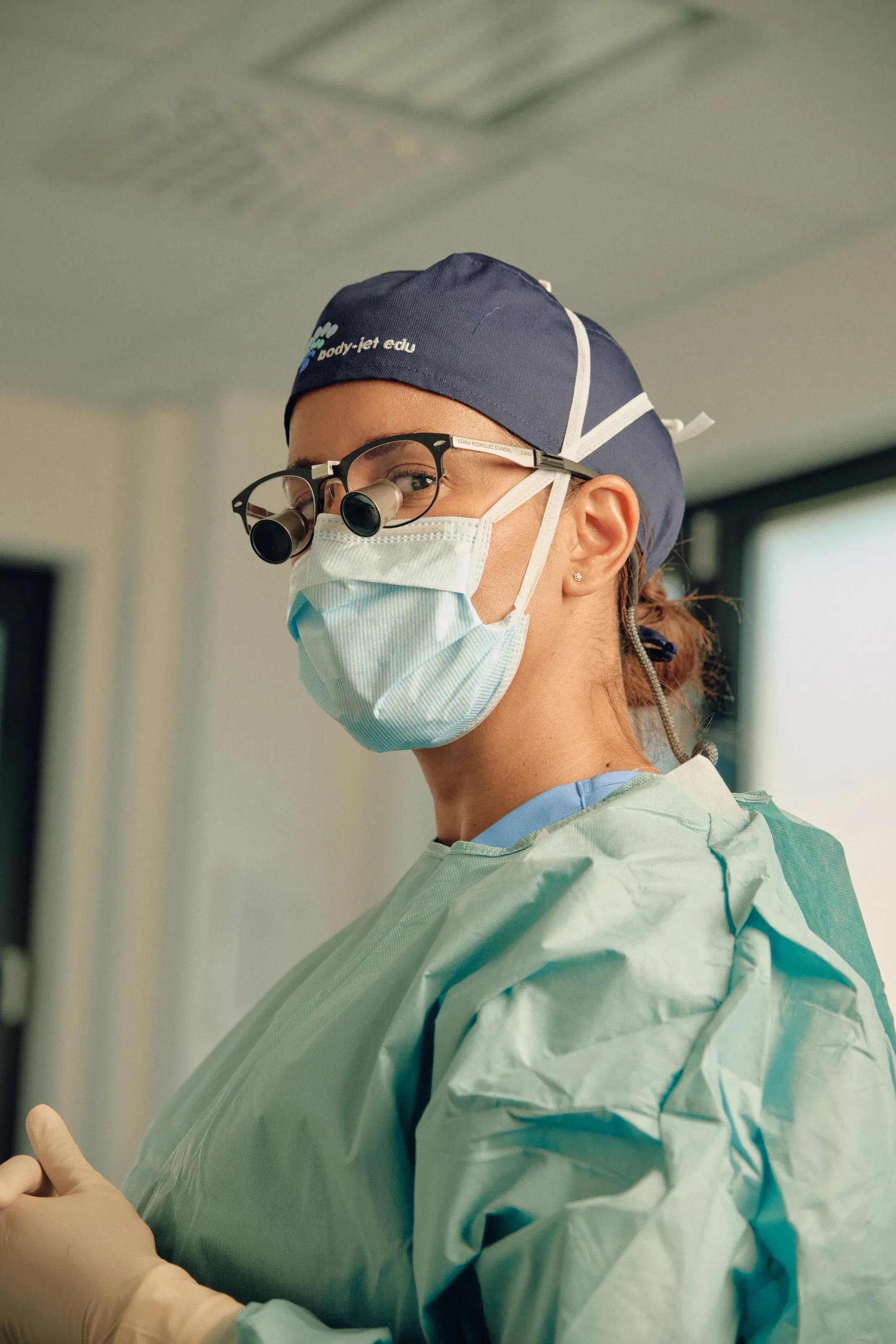 Kirurg med lupebriller og munnbind.